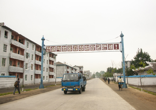 Truck below a billboard about Kim Jong il, Kangwon Province, Wonsan, North Korea