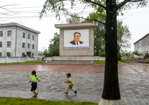 Children in front of a propaganda fresco with Kim il Sung, South Hamgyong, Hamhung, North Korea