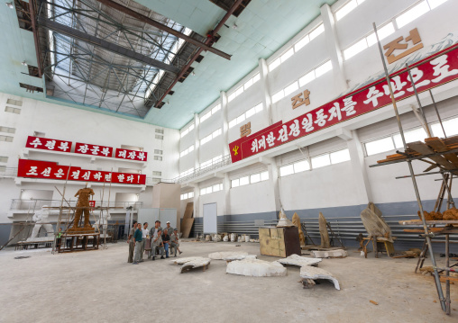 Artists working on a bronze statue at Mansudae art studio, DGC, Pyongyang, North Korea