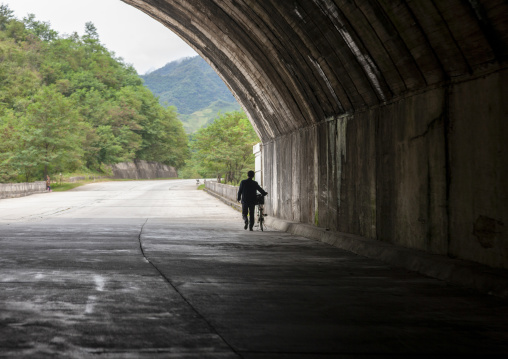 Man walking in a tunnel in rocky mountain, Kangwon Province, Wonsan, North Korea