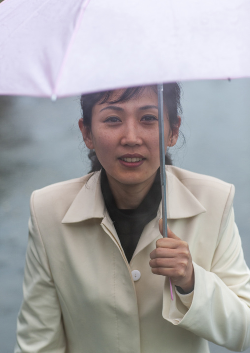 Portrait of a North Korean woman with an umbrella under the rain, South Hamgyong, Hamhung, North Korea