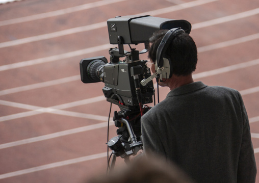 Cameraman in Kim il Sung stadium during a football game, DGC, Pyongyang, North Korea