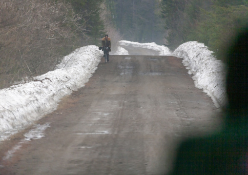 North Korean man walking on an icy road in the countryside, Ryanggang, Samjiyon, North Korea