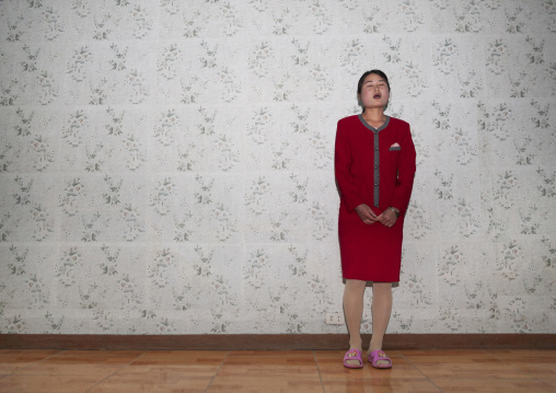 North Korean woman singing inside a house, North Hamgyong, Jung Pyong Ri, North Korea