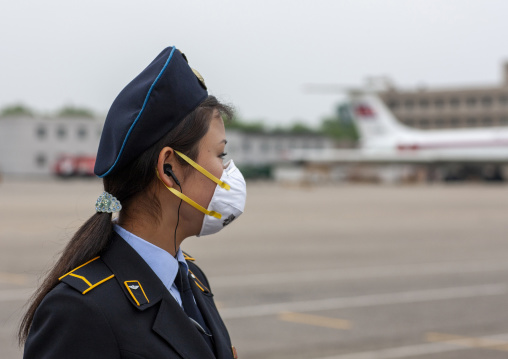 North Korean woman wearing a flu mask in Sunan international airport, DGC, Pyongyang, North Korea