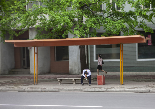 North Korean man waiting for a bus in the street, Directly Governed City, Pyongyang, North Korea