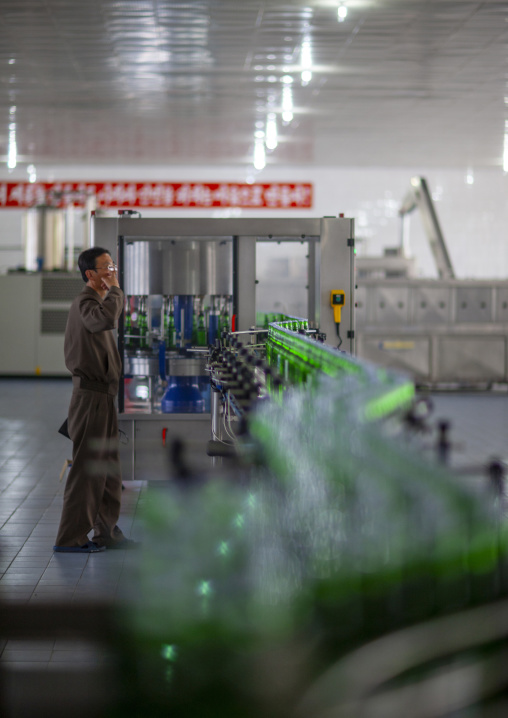 North Korean worker in kangso yaksu mineral water factory, South Pyongan, Nampo, North Korea