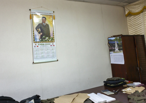 North Korean tailor wokshop with Kim Jong il calendar, DGC, Pyongyang, North Korea