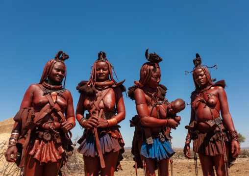 Himba tribe women covered with otjize standing in line, Cunene Province, Oncocua, Angola