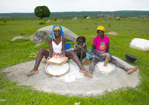 Women And Girl Grinding Grain, Village Of Caconda, Angola