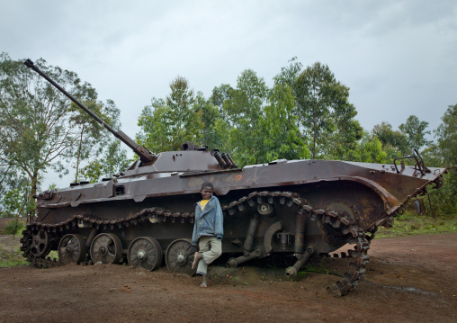 Boy In Front Of A Tank Wreck From Civil War, Bie Area, Angola