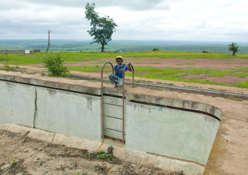 Boy With A Safety Helmet At The Top Of A Ladder, Calandula, Angola