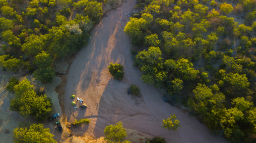 Tourists camping in a dry river, Cunene Province, Oncocua, Angola