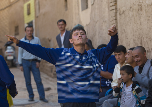 Men dancing in the street during a Wedding In Uyghur Family, Kashgar, Xinjiang Uyghur Autonomous Region, China