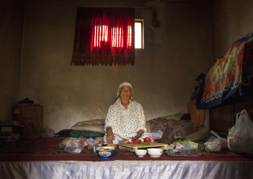 Woman Preparing Food In Her Home, Keriya, Old Town, Xinjiang Uyghur Autonomous Region, China