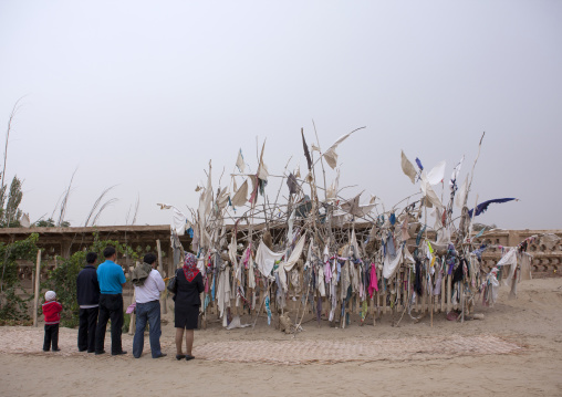 Family Praying At Imam Asim Tomb In The Taklamakan Desert, Xinjiang Uyghur Autonomous Region, China