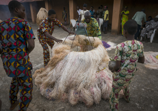 Benin, West Africa, Porto-Novo, men showing there is nobody inside the zangbeto guardian of the night in the royal palace