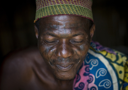 Benin, West Africa, Onigbolo Isaba, holi tribe man covered with traditional facial tattoos and scars portrait