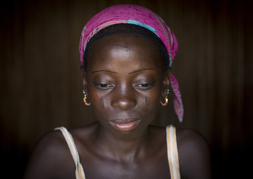 Benin, West Africa, Onigbolo Isaba, holi tribe girl covered with traditional facial tattoos and scars