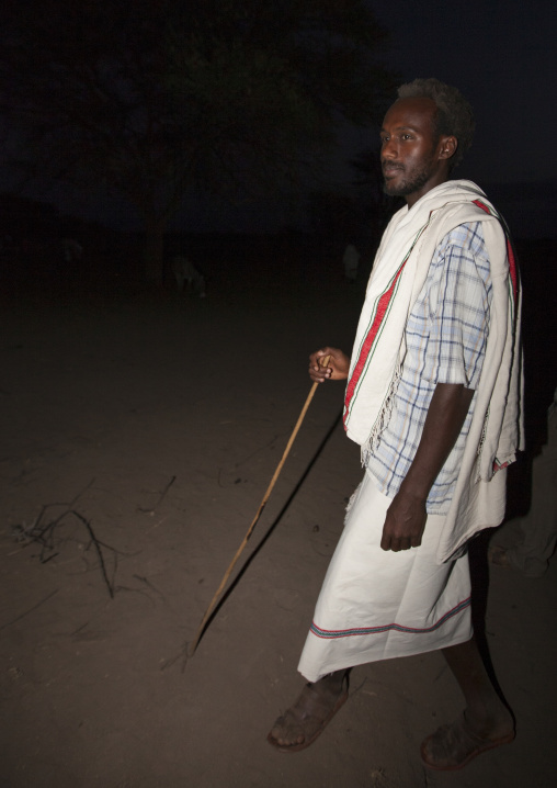 Night Shot Of A Karrayyu Tribe Man In Traditional Clothes During Gadaaa Ceremony At Night, Metahara, Ethiopia