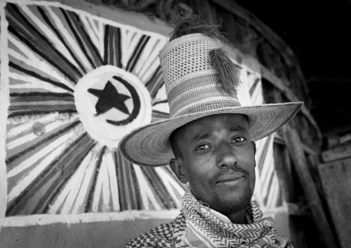 Portrait of a muslim man with tall hat inside his tukul, Alaba, Ethiopia