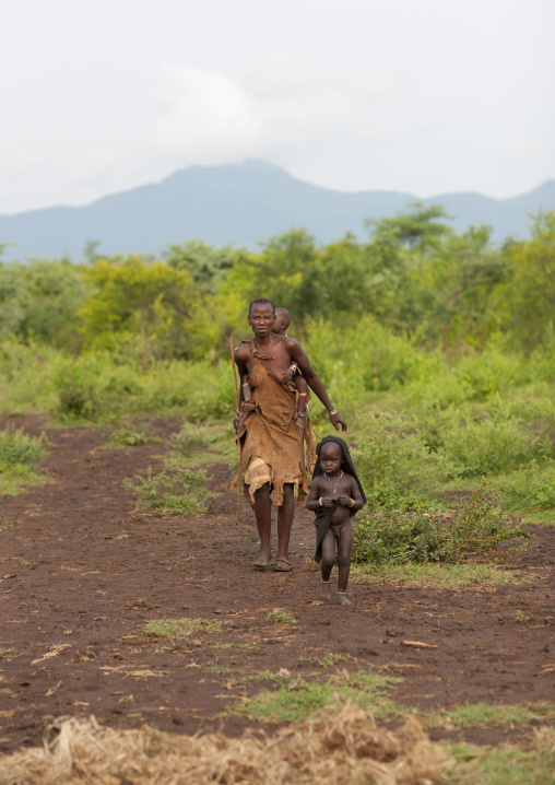 Bodi Woman Walking With Two Young Boys Carrying One Kael New Year Ceremony Omo Valley Ethiopia