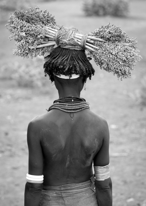 Dassanech Young Woman Wearing Beaded Necklaces And Holding Dried Plants On Her Head  Omo Valley Ethiopia