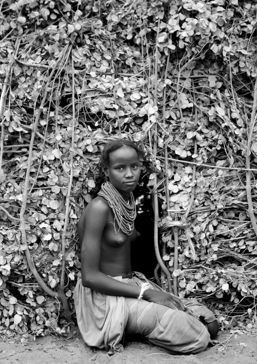 Dassanech Teenage Girl At Entrance Of Natural Materials Hut Omorate Ethiopia