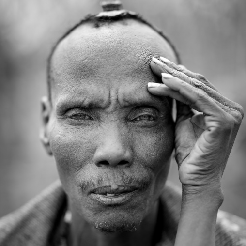 Portrait Of A Sitting Serene Dassanech Man With Hand On Face Omo Valley Ethiopia
