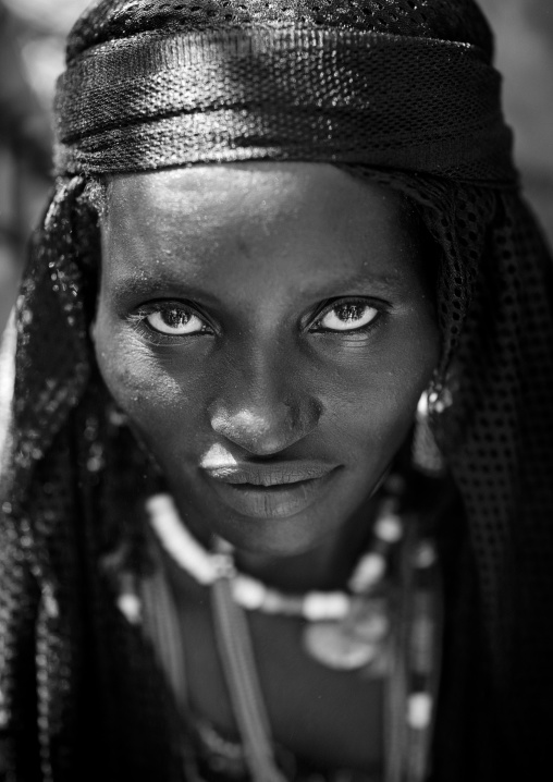 Close-up Black And White Portrait Of A Karrayyu Tribe Woman With Jewels And Black Headscarf At Gadaaa Ceremony, Metehara, Ethiopia