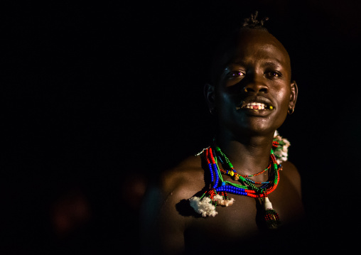 Hamer tribe teenage boy dancing at night, Omo valley, Turmi, Ethiopia