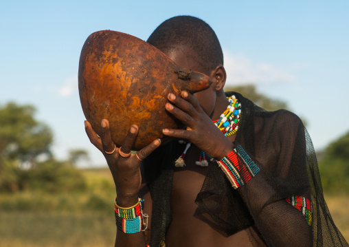 Hamer tribe whipper drinking alcohol before the bull jumping ceremony, Omo valley, Turmi, Ethiopia