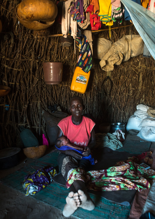 Toposa mother with her new born baby in her hut, Omo valley, Kangate, Ethiopia