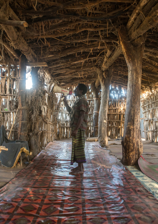 Afat tribe imam inside a wooden mosque calling will a megaphone, Afar region, Afambo, Ethiopia