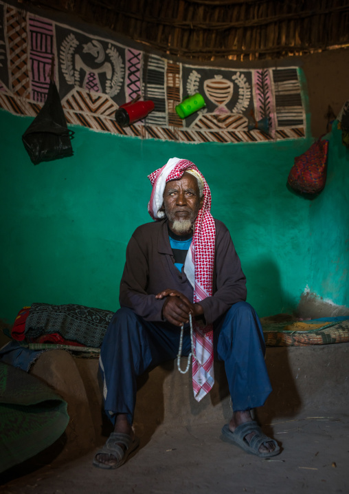 Ethiopia, Kembata, Alaba Kuito, ethiopian muslim man inside his traditional painted and decorated house