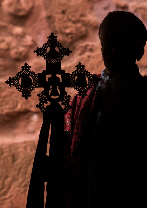 Silhouette of an ethiopian orthodox priest holding a cross, Amhara region, Lalibela, Ethiopia