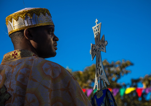 Ethiopian orthodox priest with a cross celebrating the colorful Timkat epiphany festival, Amhara region, Lalibela, Ethiopia