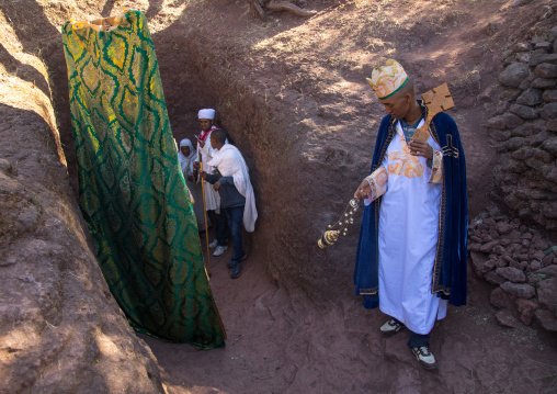 Monks taking out the crosses of Mariam rock church for Timkat celebration, Amhara region, Lalibela, Ethiopia