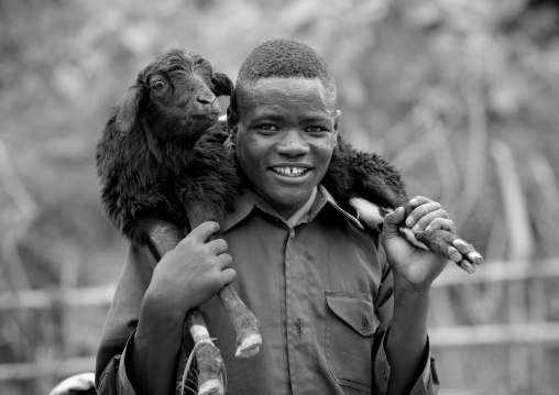 Man carrying a lamb on his shoulders, Ethiopia