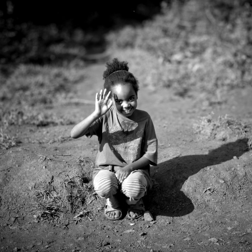 Young girl waving, Bebeka coffee plantation, Ethiopia