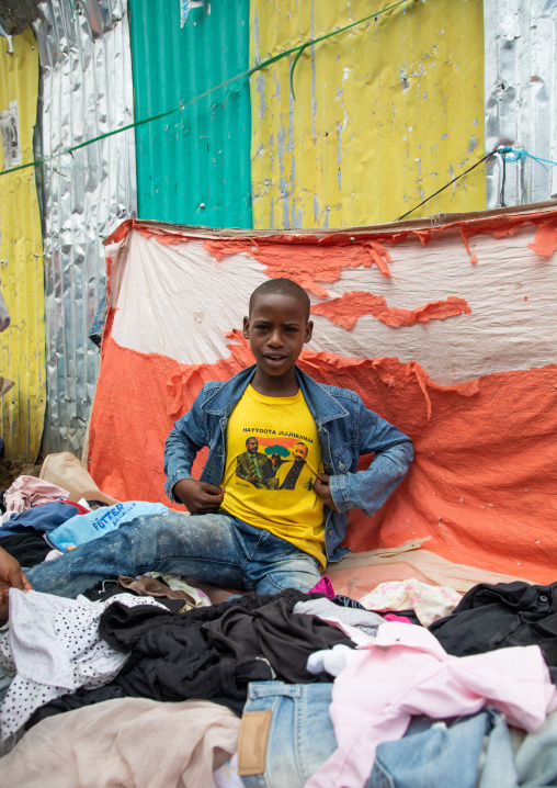 Ethiopian boy with an oromia shirt in the clothes market, Harari region, Harar, Ethiopia