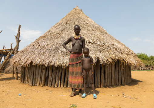 Karo tribe mother with her son called Lale who was born mingi but was saved after the tradition of killing them ended in the village, Omo valley, Korcho, Ethiopia