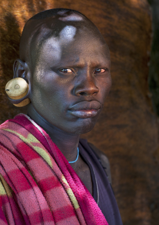 Mursi Tribe Man With Enlarged Earlobes And Wooden Earring, Chaidu, Omo Valley, Ethiopia
