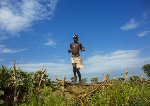 Bashada Tribe Man Jumping A Fence, Dimeka, Omo Valley, Ethiopia