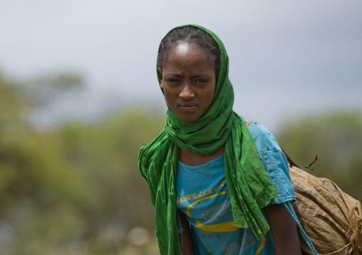 Portrait Of A Young Woman Carrying A Heavy Bag, Adama, Omo Valley, Ethiopia