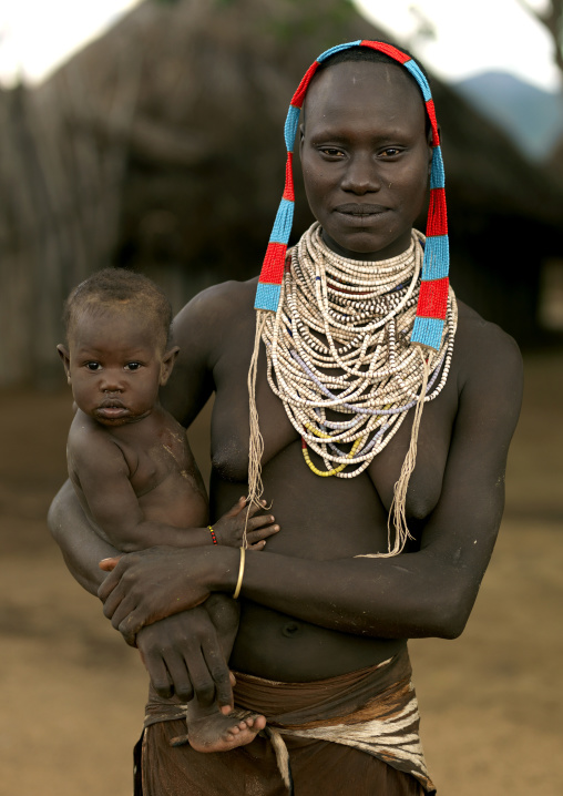 Karo Woman Carrying Baby In Her Arms And Wearing Beaded Jewels Ethiopia