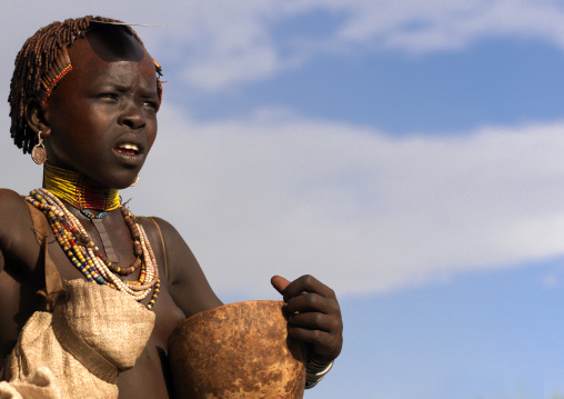 Portrait Of A Hamar Tribe Girl Holding A Calabash And Wearing A Bala On Her Head, Turmi, Omo Valley, Ethiopia