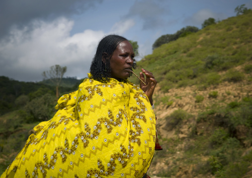 Borana Woman Dressed With Yellow Loincloth Chewing Stick Of Miswak Ethiopia