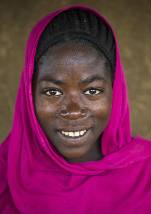 Smiling woman from menit tribe wearing a pink headscarf, Jemu, Omo valley, Ethiopia