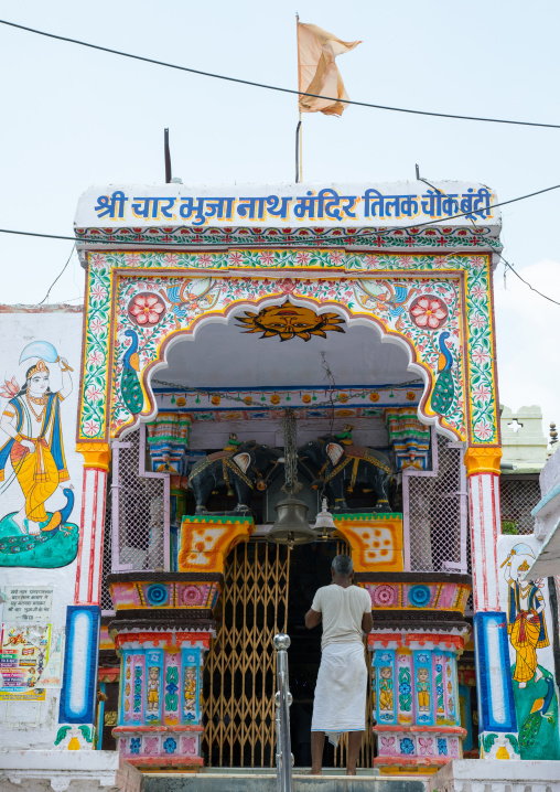 Indian man at the entrance of a temple, Rajasthan, Bundi, India